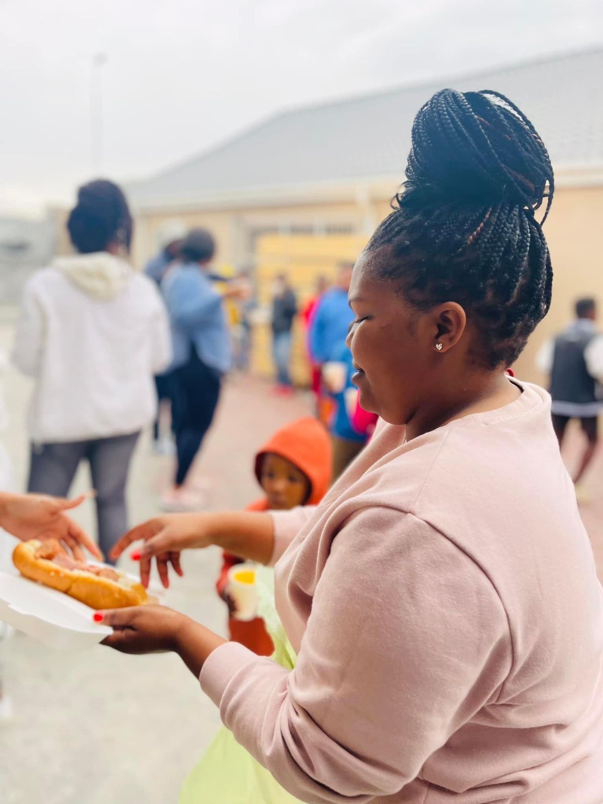 A girl eating a hotdog